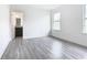 Bright bedroom with wood-look floors and access to bathroom at 623 Sylvan Ramble Rd, Davenport, FL 33837