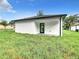 Covered back patio with access to grassy backyard at 623 Sylvan Ramble Rd, Davenport, FL 33837