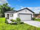 Modern house with a white exterior and a two-car garage at 623 Sylvan Ramble Rd, Davenport, FL 33837