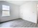 Bright bedroom with grey vinyl flooring and a large window at 623 Sylvan Ramble Rd, Davenport, FL 33837