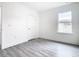 Light-filled bedroom with grey flooring and a window at 623 Sylvan Ramble Rd, Davenport, FL 33837