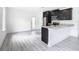 Modern kitchen with dark cabinets, granite counters and stainless steel appliances at 623 Sylvan Ramble Rd, Davenport, FL 33837