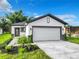Modern house with a white exterior and a two-car garage at 623 Sylvan Ramble Rd, Davenport, FL 33837