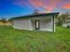 Covered back patio with access to grassy backyard at 623 Sylvan Ramble Rd, Davenport, FL 33837