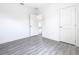 Well-lit bedroom, featuring grey flooring and access to another room at 623 Sylvan Ramble Rd, Davenport, FL 33837