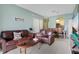 Open concept living room and dining area with leather sofas and view of kitchen at 2300 Silver Palm Dr # 303, Kissimmee, FL 34747