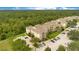 Aerial view of an apartment building complex with ample parking and lush green surroundings at 2300 Silver Palm Dr # 303, Kissimmee, FL 34747