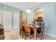 Dining area with wood table and six chairs, adjacent to kitchen at 2300 Silver Palm Dr # 303, Kissimmee, FL 34747