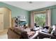 Spacious living room with leather sofas, large TV, and balcony access at 2300 Silver Palm Dr # 303, Kissimmee, FL 34747