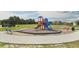 Community playground with slides, climbing structures, and benches at 199 Bull Frog Ln, Umatilla, FL 32784
