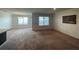 Spacious living room with neutral carpeting and large windows at 3073 Royal Tern Dr, Winter Haven, FL 33881
