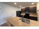Modern kitchen with dark cabinetry and granite countertops at 3073 Royal Tern Dr, Winter Haven, FL 33881