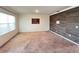Living room with wood-like accent wall and carpeted floors at 3073 Royal Tern Dr, Winter Haven, FL 33881