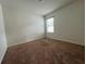 Well-lit bedroom featuring carpeted flooring and a window with blinds at 3073 Royal Tern Dr, Winter Haven, FL 33881