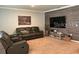 Spacious living room with brown leather sectional sofa at 3073 Royal Tern Dr, Winter Haven, FL 33881