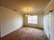 Dining room with carpeted floor, chandelier, window with blinds and access to a patio at 3073 Royal Tern Dr, Winter Haven, FL 33881