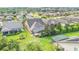 Aerial view showcasing a home with a screened-in pool and lush landscaping at 356 Toldedo Rd, Davenport, FL 33837