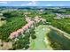 Aerial view of community, featuring a golf course, lake, and numerous residential buildings at 1301 Tuscan Ter # 9403, Davenport, FL 33896