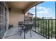 Spacious screened balcony with seating area overlooking trees and community at 1301 Tuscan Ter # 9403, Davenport, FL 33896