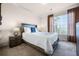 Bright bedroom with a queen-size bed, nightstands, and ample natural light at 1301 Tuscan Ter # 9403, Davenport, FL 33896