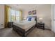 Bedroom with a bed, nightstands, and large window at 1301 Tuscan Ter # 9403, Davenport, FL 33896