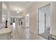 Long hallway with tile floors, offering views into the kitchen and bathroom at 8839 Interlocking Ct, Davenport, FL 33896
