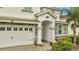 Two-story home with stone accents, attached garage, and landscaping at 8839 Interlocking Ct, Davenport, FL 33896