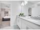 Double vanity bathroom with gray countertops and modern lighting at 8839 Interlocking Ct, Davenport, FL 33896