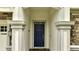 Elegant front door entry with stone accents and columns at 8839 Interlocking Ct, Davenport, FL 33896