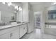 Bathroom with double vanity, soaking tub, and walk-in shower at 8839 Interlocking Ct, Davenport, FL 33896
