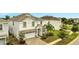 Two-story house with white exterior and a two-car garage at 8839 Interlocking Ct, Davenport, FL 33896