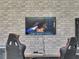Game room features two gaming chairs, large TV, and game console at 8839 Interlocking Ct, Davenport, FL 33896