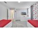 ' bedroom with twin beds and access to bathroom and hallway at 8839 Interlocking Ct, Davenport, FL 33896