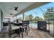 Covered patio with outdoor dining, grill, and pool access at 8839 Interlocking Ct, Davenport, FL 33896