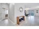 Bright and airy entryway with wood console table and blue stools at 8839 Interlocking Ct, Davenport, FL 33896