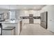 Modern kitchen with white cabinets, stainless steel appliances, and an island at 8839 Interlocking Ct, Davenport, FL 33896