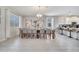 Bright dining area with modern light fixture and kitchen view at 8839 Interlocking Ct, Davenport, FL 33896