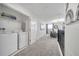 Convenient laundry room with washer, dryer, and shelving at 8839 Interlocking Ct, Davenport, FL 33896