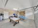 Finished garage with pool table, ping pong, and seating at 8839 Interlocking Ct, Davenport, FL 33896