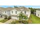 Two-story house with white exterior and a two-car garage at 8839 Interlocking Ct, Davenport, FL 33896