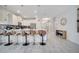 Modern kitchen with island seating and view of the entryway at 8839 Interlocking Ct, Davenport, FL 33896