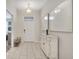 Bright entryway with tile floors, storage bench, and elegant wall art at 8839 Interlocking Ct, Davenport, FL 33896