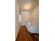 Upstairs hallway with wood-look flooring and white walls at 5150 Picadilly Circus Ct # 7, Orlando, FL 32839