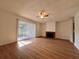 Sunlit living room showcasing laminate flooring, fireplace, and patio access at 5150 Picadilly Circus Ct # 7, Orlando, FL 32839