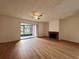 Spacious living room featuring a brick fireplace and laminate wood flooring at 5150 Picadilly Circus Ct # 7, Orlando, FL 32839