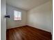 Bright bedroom featuring wood-look floors and a window at 5150 Picadilly Circus Ct # 7, Orlando, FL 32839