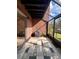 Bright screened patio with tile floor and brick walls at 5150 Picadilly Circus Ct # 7, Orlando, FL 32839