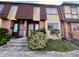 Brick townhouse with brown roof and landscaping at 5150 Picadilly Circus Ct # 7, Orlando, FL 32839