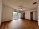 Main bedroom with laminate wood flooring and private balcony access at 5150 Picadilly Circus Ct # 7, Orlando, FL 32839