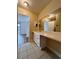 Bathroom vanity with white cabinets and a large mirror at 5150 Picadilly Circus Ct # 7, Orlando, FL 32839